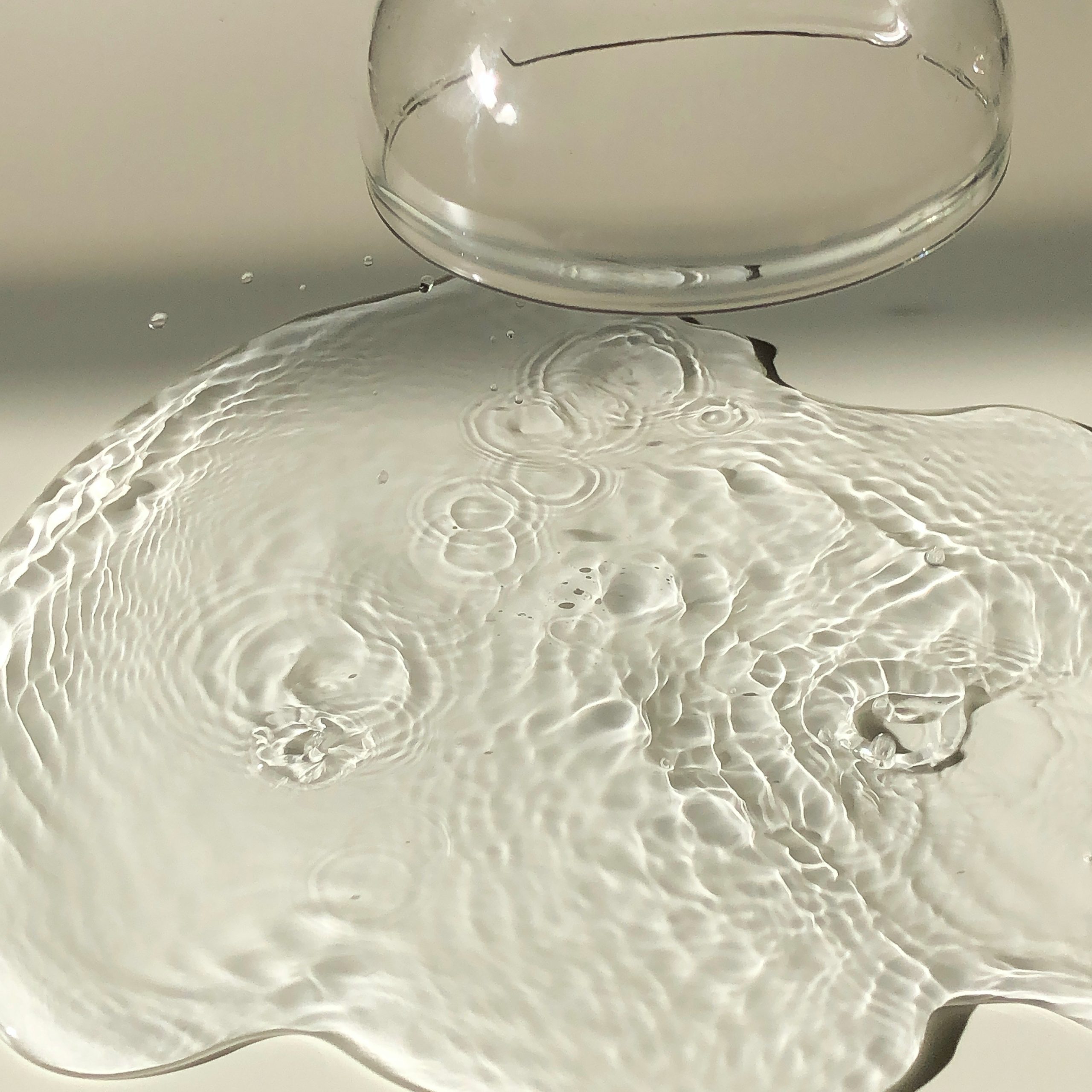 A 3d model of a glass of water on a table.