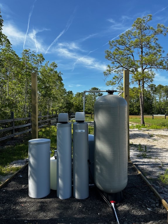 The Rainking water filtration system is strategically placed in a serene wooded area to provide efficient water purification.