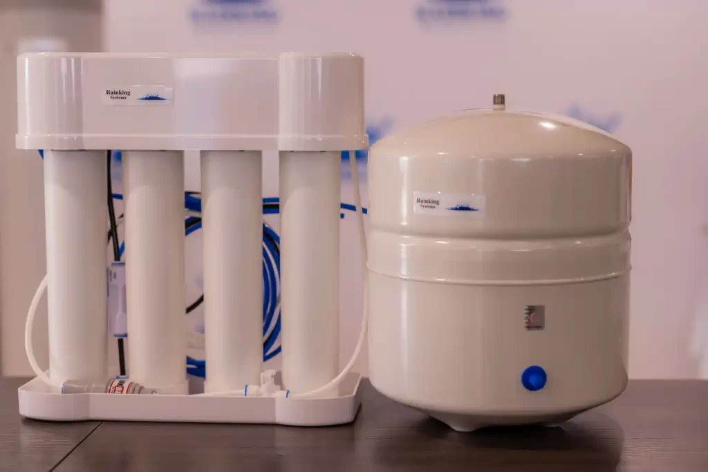 A water purification system with a filter and a bottle of water.